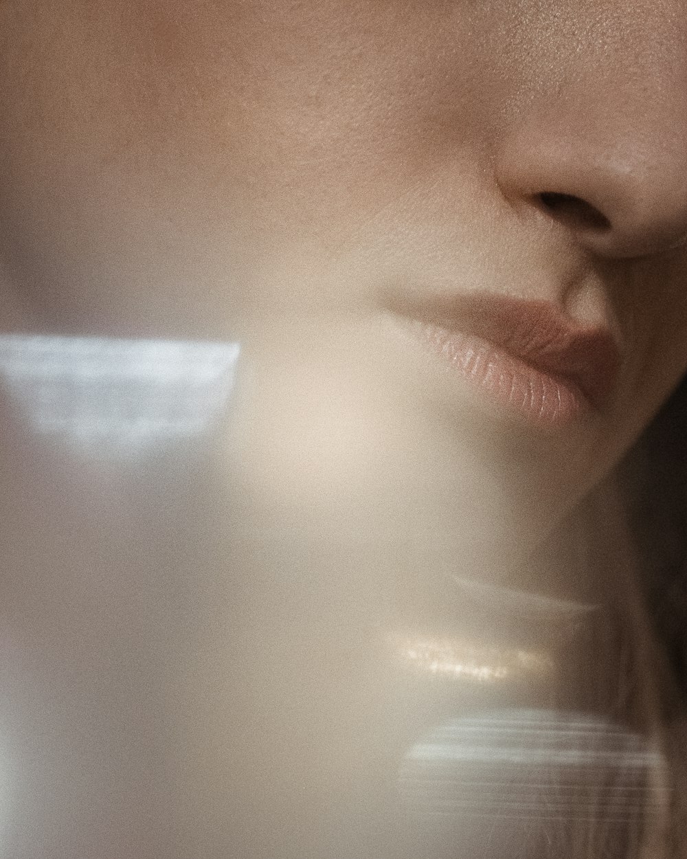 Soft daylight across a woman's cheek and lips